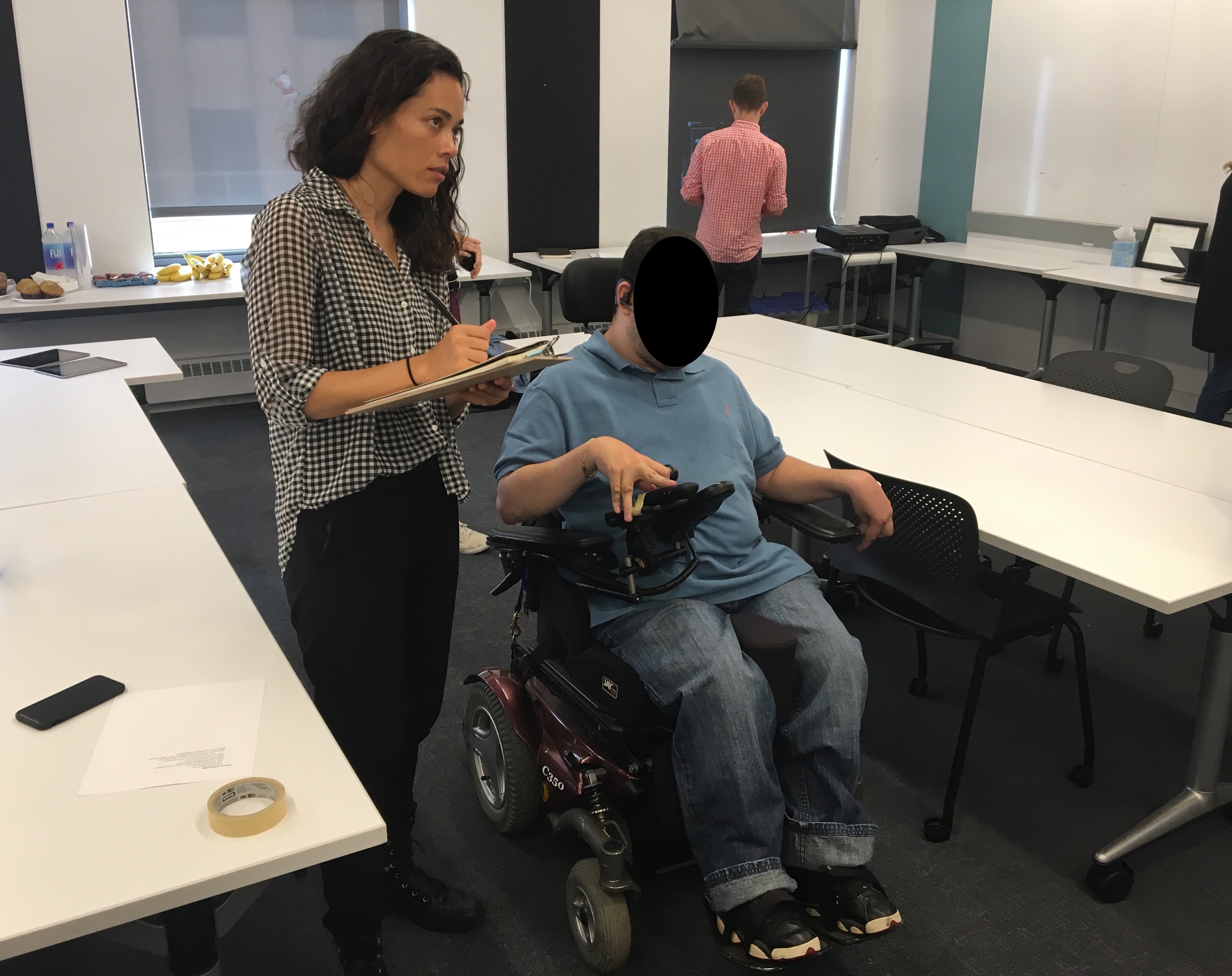 Shannon Holloway conducting accessibility interface testing with a research participant with motor impairments.