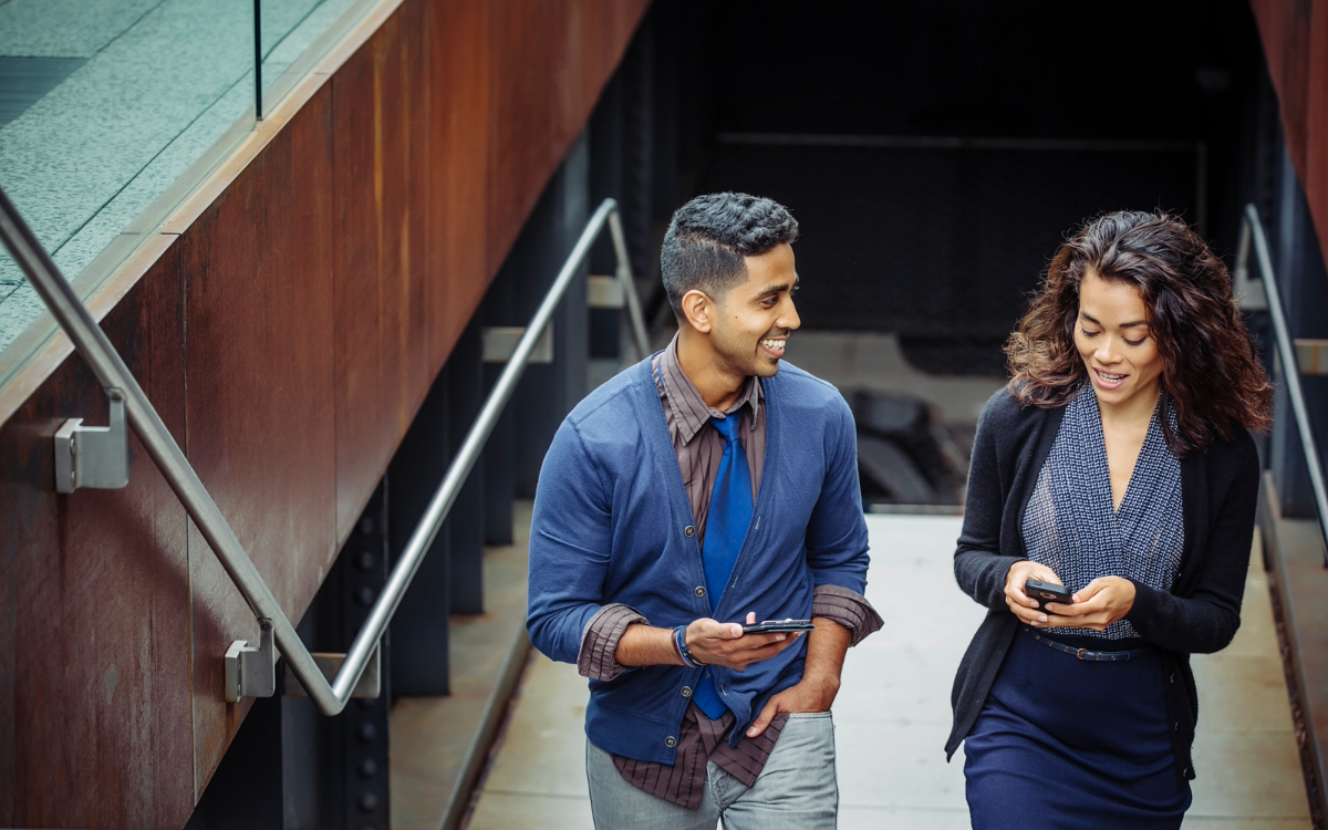 Shannon and man walking up modern staircase