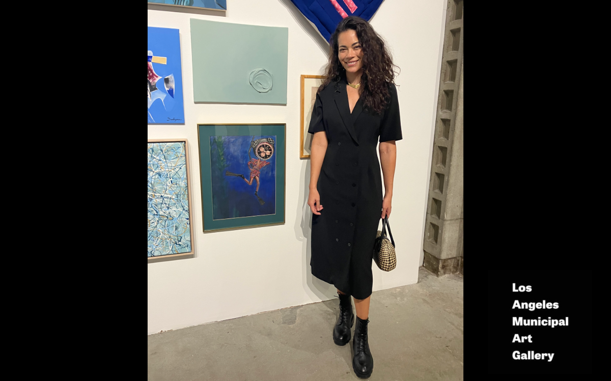 Shannon standing next to painting in gallery